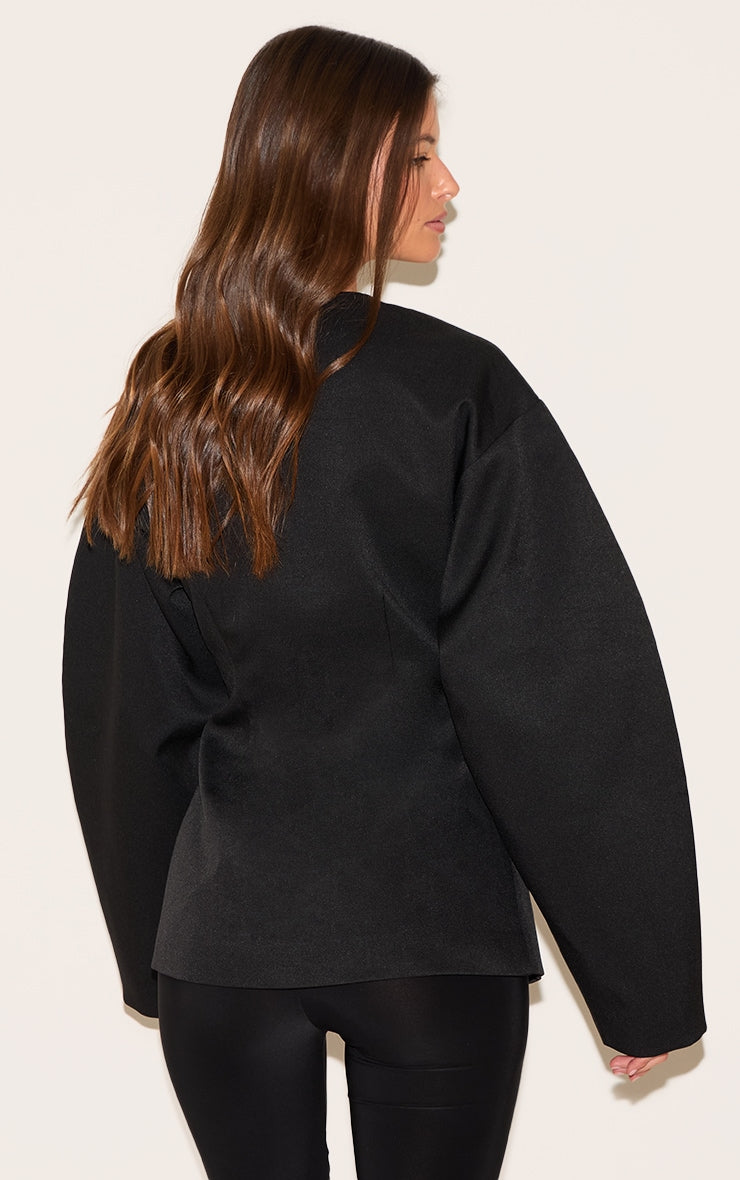 https://cdn-img.prettylittlething.com/1/0/a/5/10a5917147c965a1fef64c938aeb1efd1cea8def_cnm1407_2_black_cocoon_sleeve_cinched_waist_pocket_blazer.jpg