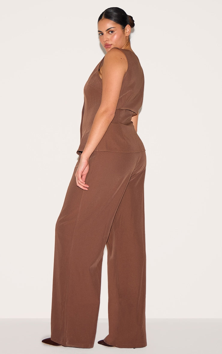 https://cdn-img.prettylittlething.com/7/f/4/e/7f4e5bc148dc6c8a00d0104d808493839d9e374a_CNL8284_2_plus_chocolate_brown_high_neck_waistcoat_straight_leg_jumpsuit.jpg