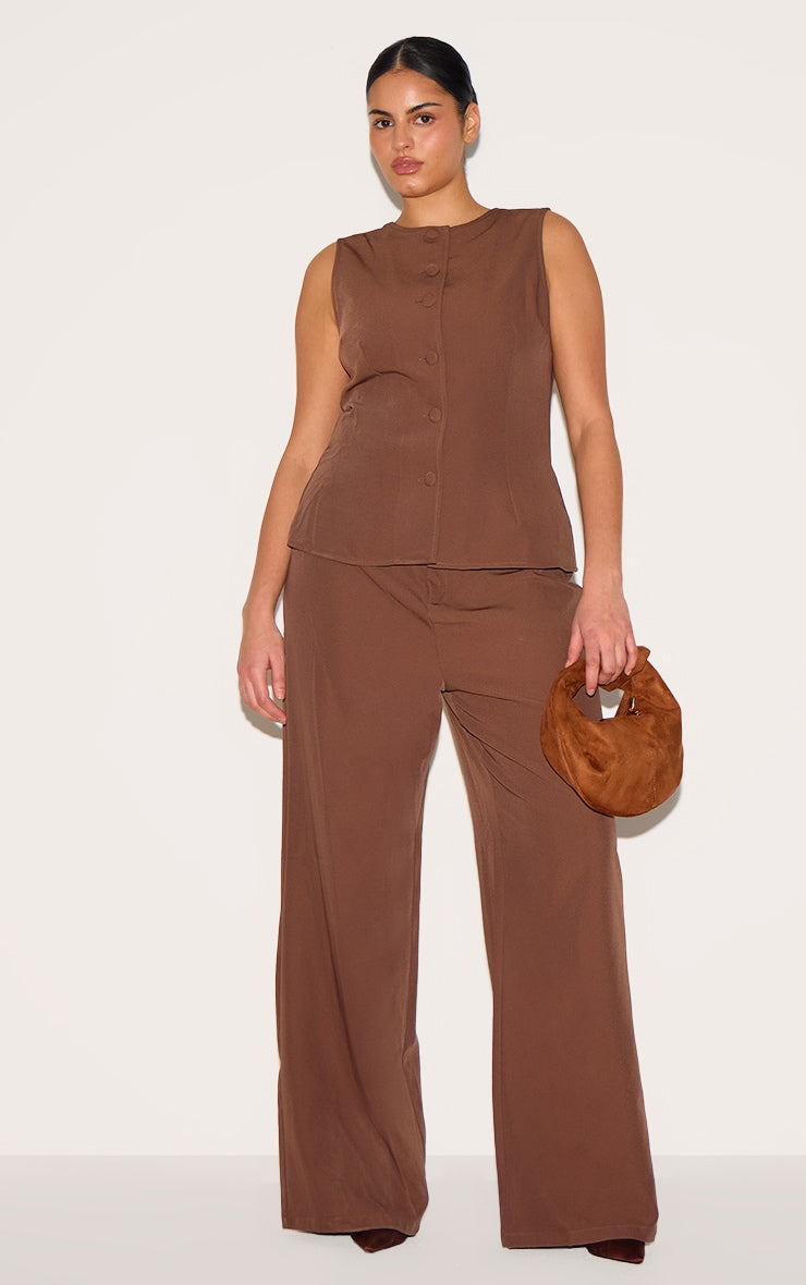 https://cdn-img.prettylittlething.com/b/0/4/f/b04f85997609835d28767db32de1d826f66e7923_CNL8284_3_plus_chocolate_brown_high_neck_waistcoat_straight_leg_jumpsuit.jpg