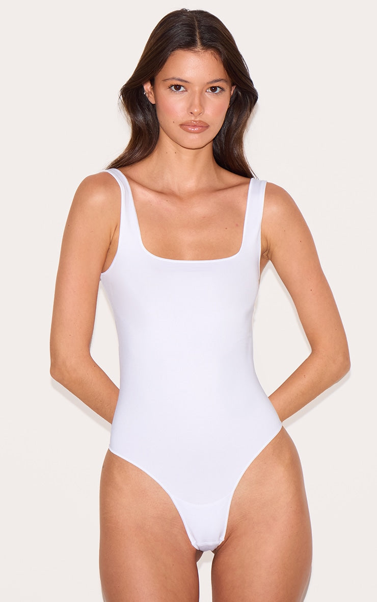 https://cdn-img.prettylittlething.com/4/c/5/4/4c54313824a4475558313e451f25bd6715075c42_CNI9155_4_white_seamless_lingerie_bodysuit.jpg