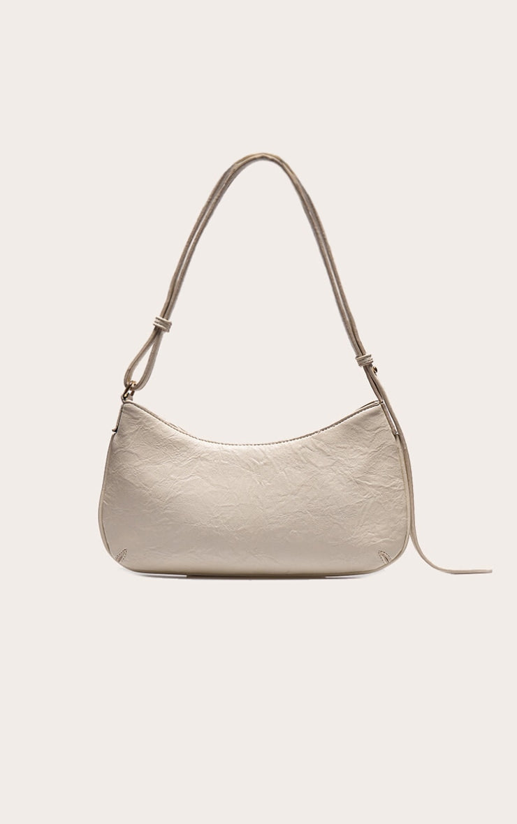https://cdn-img.prettylittlething.com/5/3/f/1/53f10ee222a2ca2c9c05c254e3003c4d1c057238_CNL7999_1_cream_textured_pu_baguette_shoulder_bag.jpg