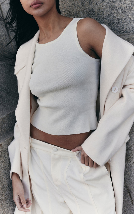 https://cdn-img.prettylittlething.com/9/1/d/8/91d82880e15238a66ba96e5841350790f1e73194_CNL6071_1_cream_fine_knit_racer_neck_top.jpg
