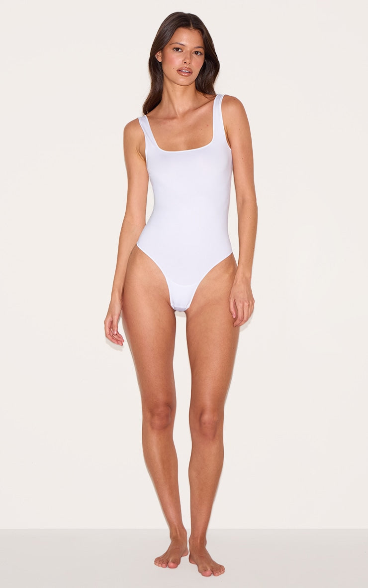 https://cdn-img.prettylittlething.com/9/5/0/7/950723690de84f8f299095f36e41031c5a4d1cb3_CNI9155_3_white_seamless_lingerie_bodysuit.jpg