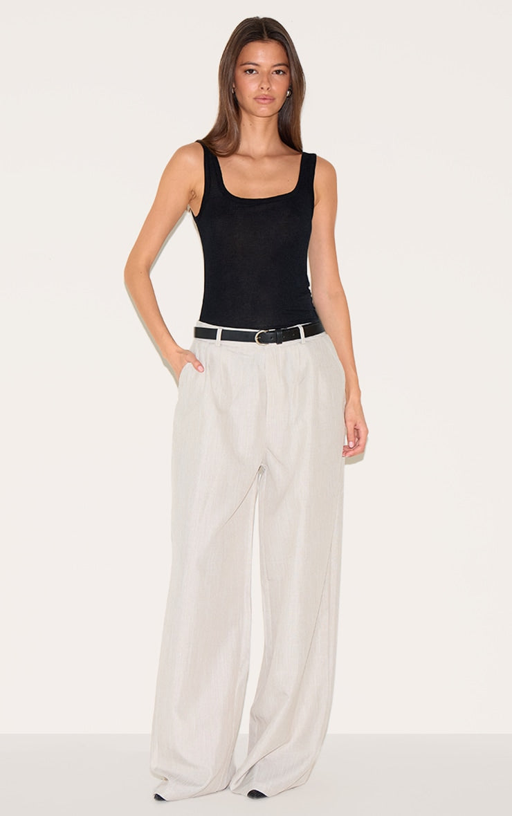 https://cdn-img.prettylittlething.com/9/5/7/0/95709d898ee2214c00bad1881f2540c74ce293cc_CNM3750_3_black_sheer_soft_touch_scoop_neck_long_vest_top.jpg